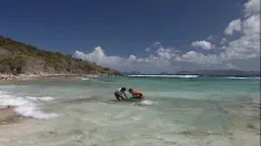 Thumbnail of Gina, A Girl In A Net Has A Threesome In A Tropical Beach