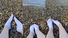 Thumbnail of Playing With My Feet In White Socks With Pebbles On The Beach